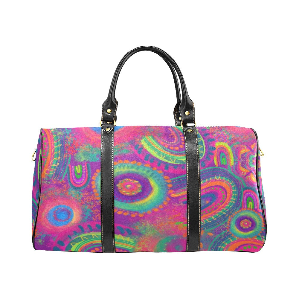 Colorful paisley patterned bag with black handles on a white background