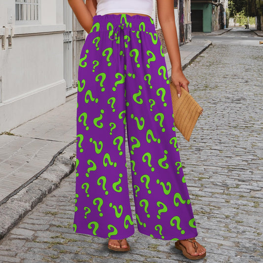 Person wearing purple pants with green question marks on a street.