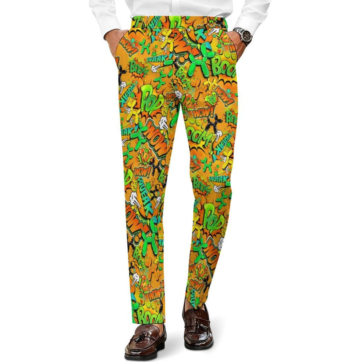 A person wearing slim-fit trousers with an all-over graffiti-style print in orange, yellow, green, and black, paired with a white shirt and brown loafers against a plain white background.