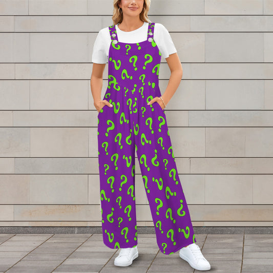 Person wearing purple overalls with green question marks against a wooden wall.