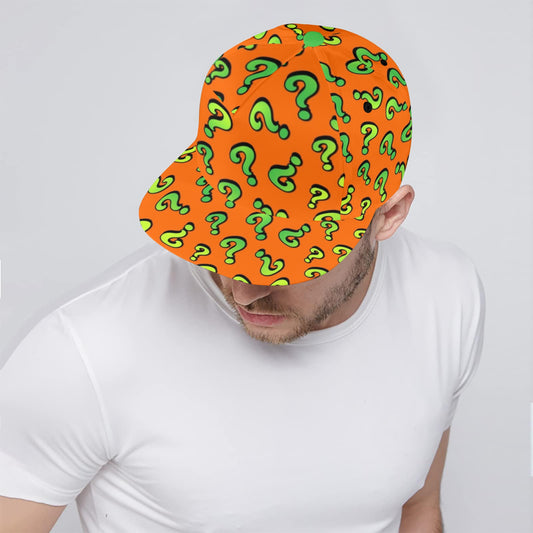 Person wearing an orange cap with green question marks on a plain background