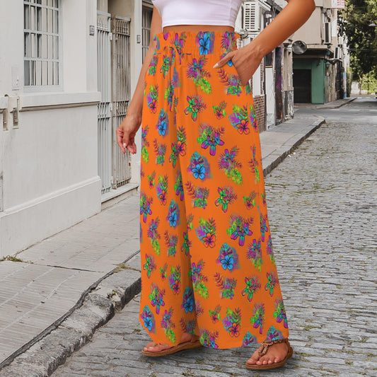 Person wearing bright orange floral pants with balloon dogs walking on a street.