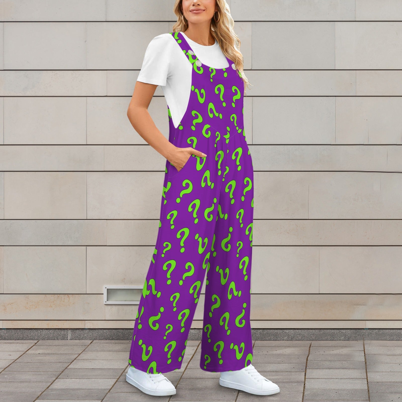 Magician wearing a purple jumpsuit with green question mark pattern against a wooden wall.