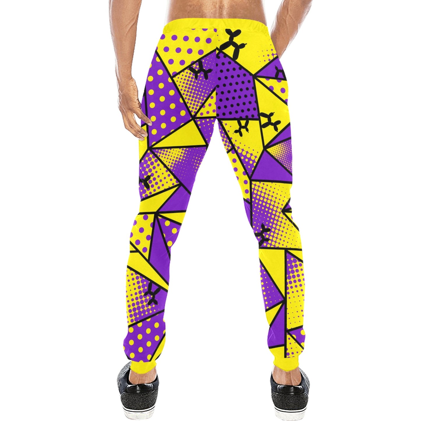 A person shown from the back wearing bright yellow and purple geometric print jogger pants with black shoes, on a plain white background.