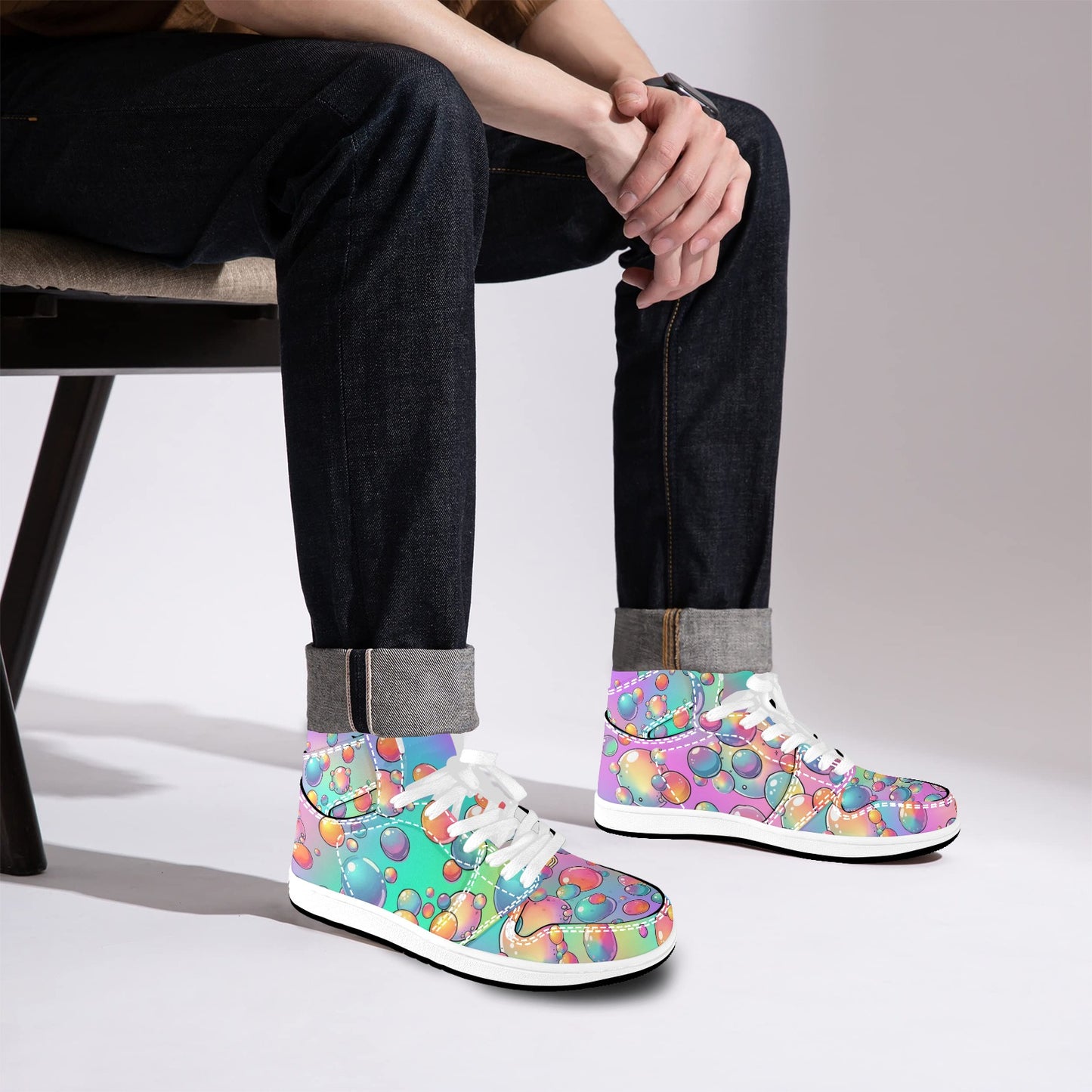 Person wearing colorful patterned sneakers sitting on a chair.