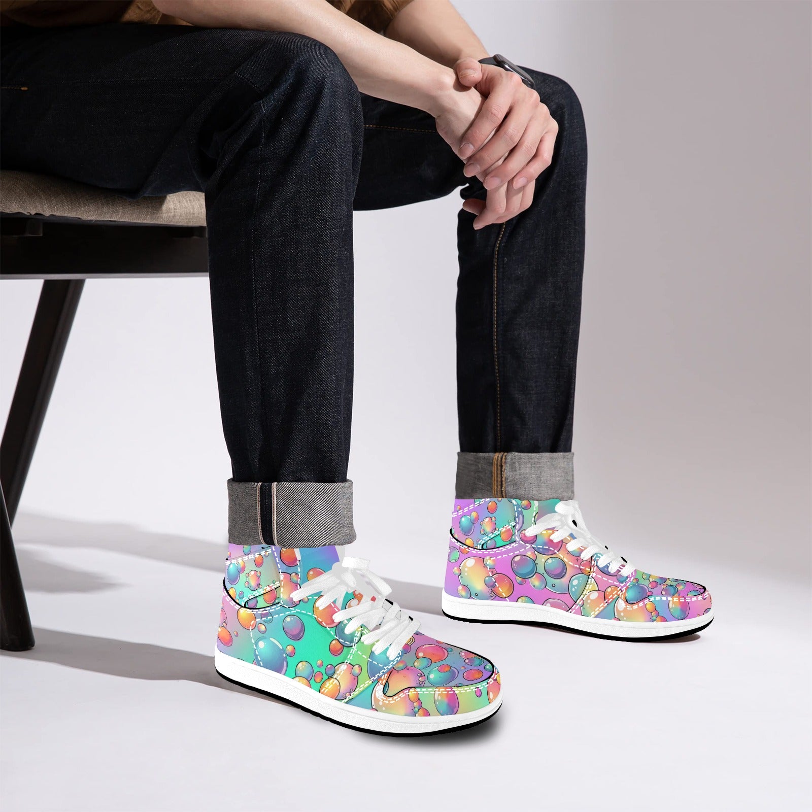 Person wearing colorful patterned sneakers sitting on a chair.