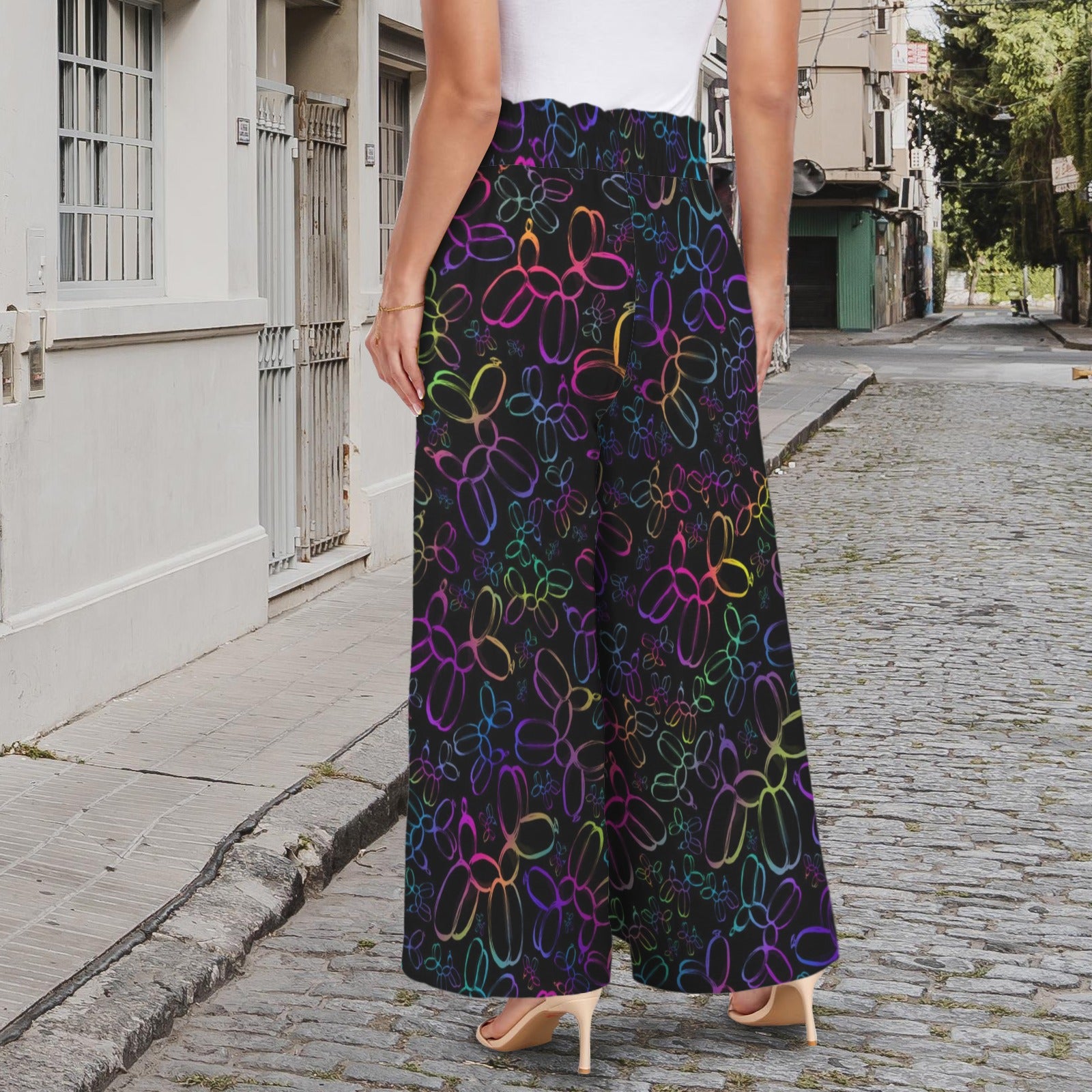 Person wearing colourful balloon dog patterned pants on a street