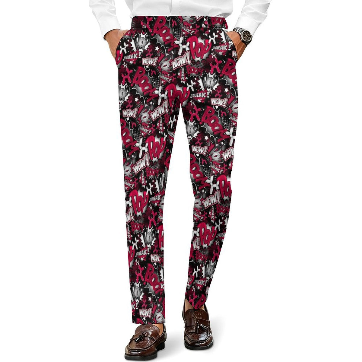 A person wearing slim-fit trousers with an all-over abstract graffiti-style print in red, black, white, and gray, paired with a white shirt and brown loafers against a plain white background.