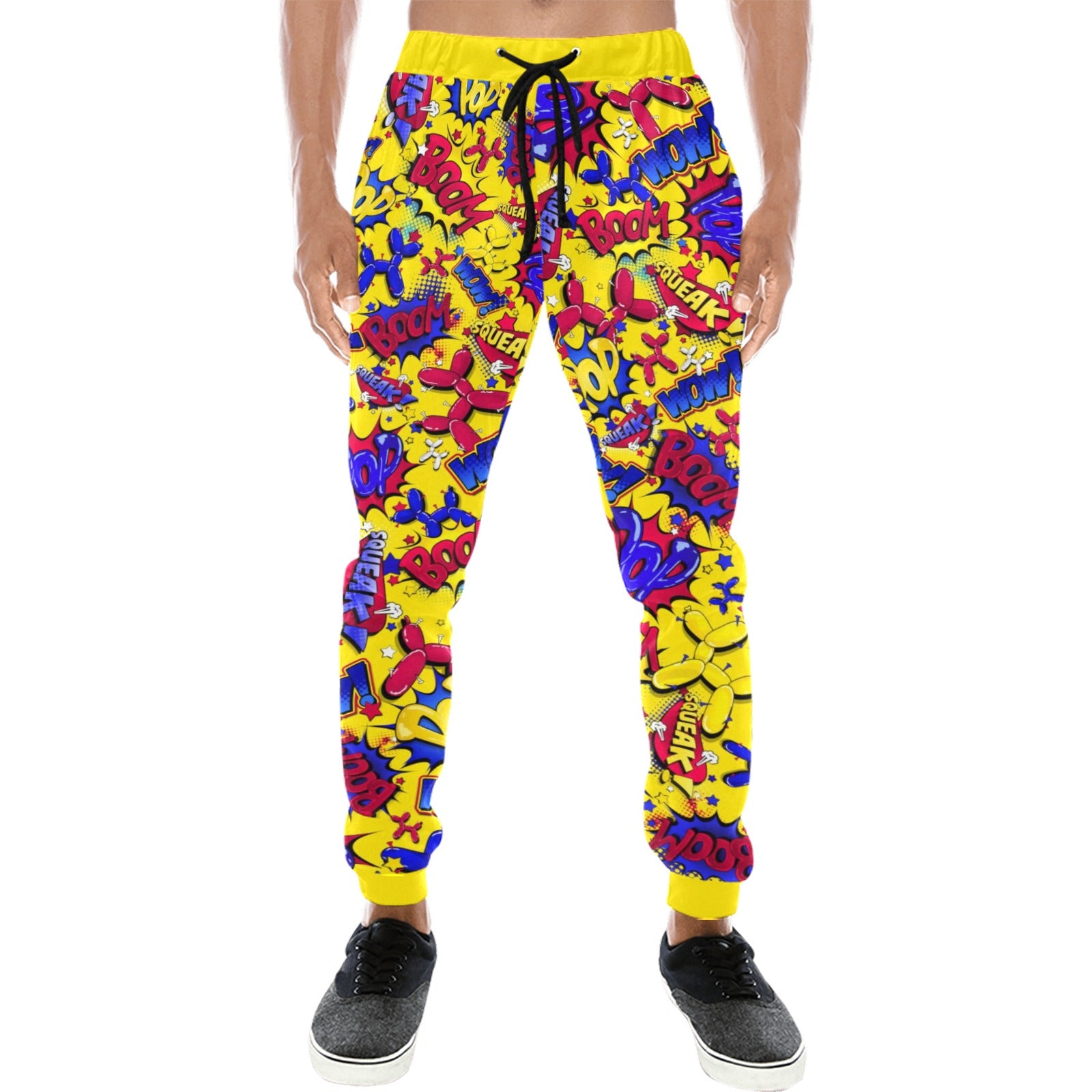 A person wearing bright yellow jogger-style pants covered in a dense multicolor graffiti-style print with red, blue, purple, and pink lettering, shown against a plain white background.