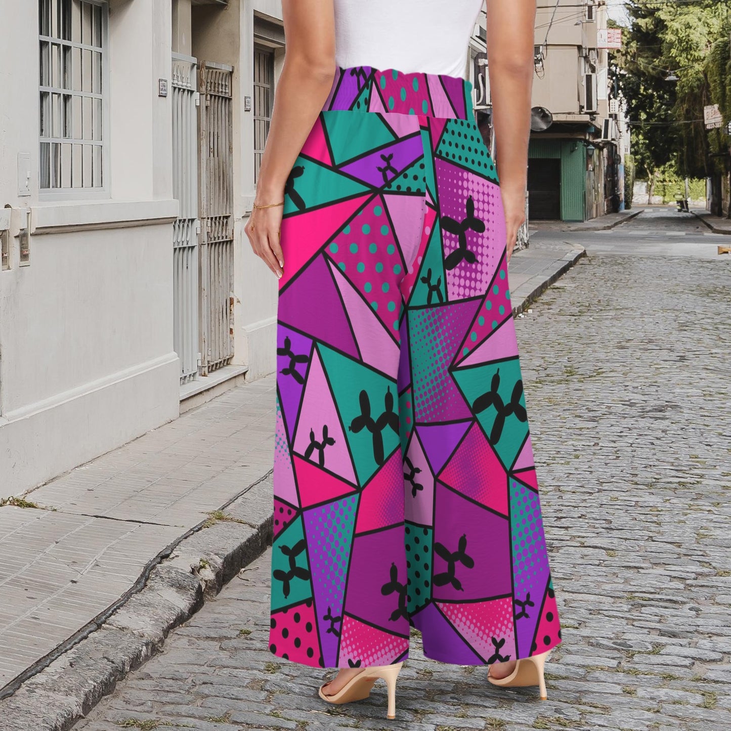 Person wearing geometric pattern pink and purple pants with balloon dog design